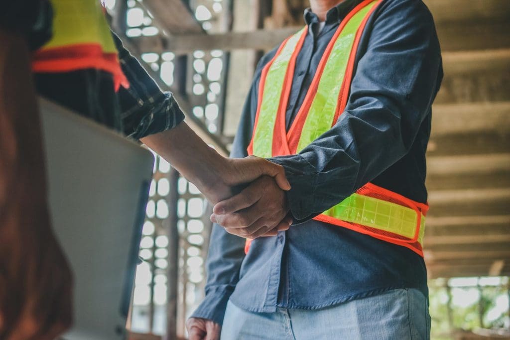 AYN Services team member shaking hands with a local commercial builder after completing a builders clean in Townsville.